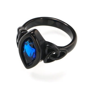 Detail of a vintage black titanium ring with marquise cut blue gem and Celtic knot work