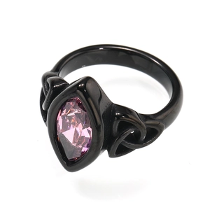 Detail view of gothic black titanium ring featuring a pink marquise gemstone inlay
