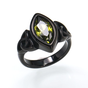 Close-up of black titanium ring featuring marquise-cut olive green gemstone detail