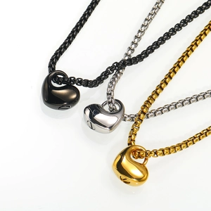 Detailed close-up of heart cremation pendants in black, gold, and silver finishes