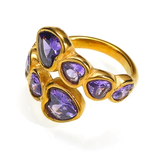 Close-up of golden crossover ring featuring six purple heart-shaped zircon stones