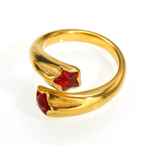 Detailed close-up of an 18K gold star ring with ruby red cubic zirconia stones
