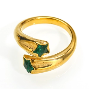 Detail of adjustable gold ring featuring two green star-shaped cubic zirconia stones