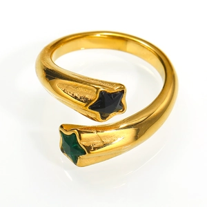 Macro detail of gold-plated star ring featuring black and green zircon stone accents