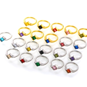 Detailed close-up of square zircon rings in multiple colors with twisted metal bands