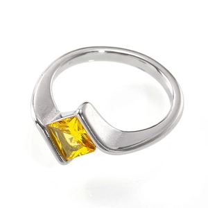 Detailed close-up of a square-cut yellow zircon set in a silver minimalist wrap ring