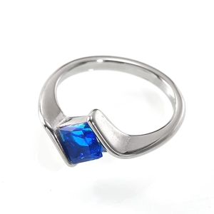 Detail view of square-cut blue gemstone tension-set in a silver minimalist ring band