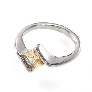 Macro detail of silver asymmetric ring featuring a princess cut champagne gemstone