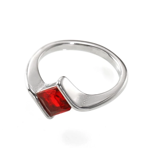 Detail shot of a silver steel ring featuring a square-cut red zircon in a modern bezel