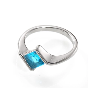 Detail view of silver ring with light blue square zircon and fluid curved setting