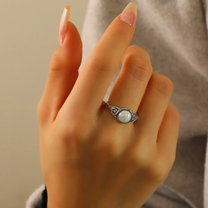 Vintage silver titanium ring with round white gemstone and hollow filigree pattern