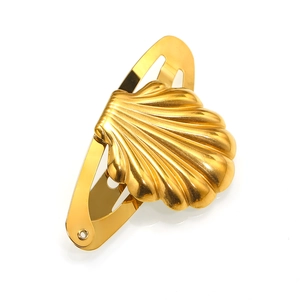 Detailed view of a golden starfish seashell hair clip with glossy metallic texture