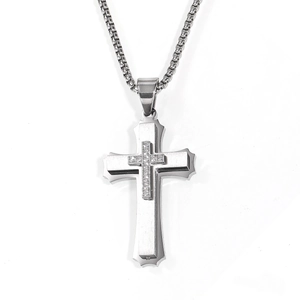 Macro shot of double-layered stainless steel cross pendant with cubic zirconia and box chain
