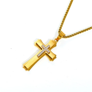 Macro shot of gold layered cross pendant with brushed texture and zircon micro-pave