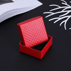 Macro detail of red jewelry gift box with rhombus texture and black flocking lining