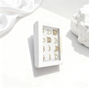 Set of 12 stainless steel gold rings with heart and geometric patterns in white jewelry box