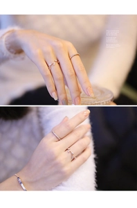Détail de la bague feuille d'olivier en or rose et de l'anneau en zircone sur la main