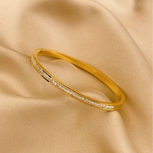 Detail shot of a luxury gold-plated bangle with sparkling square-cut zircon stones
