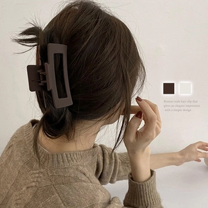 Elegant rectangular matte dark brown hair claw clip shown on model in a Korean style