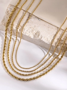 Detailed view of four golden stainless steel rope chains in various thicknesses