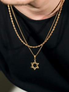Macro view of gold plated stainless steel rope chain and hexagram star pendant