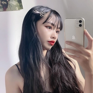 Creative silver scissor hair clip with sparkling rhinestones worn by a model