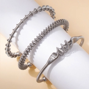Detail der silbernen Federarmbänder mit Metalldrahtspulen und Kugelendkappen