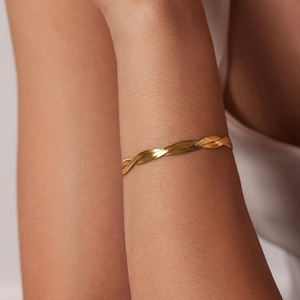 Minimalist double-layer hand-woven gold-plated snake chain bracelet on a wrist