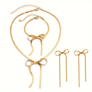 Set gioielli dorati con collana a spina di pesce, fiocco con nappe e orecchini pendenti