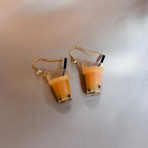 Close-up of miniature milk tea cup earrings with gold hooks and clear crystal studs