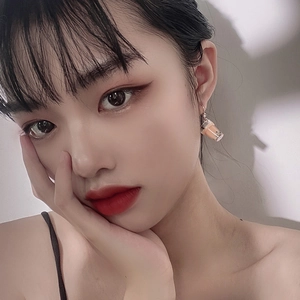 Cute milk tea cup drop earrings with tiny boba pearls and metal hooks worn by a model