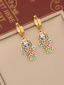 Detail of gold Hamsa earrings with colorful enamel evil eyes on a premium display box