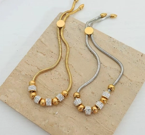 Detalle de pulseras de serpiente ajustables con brillantes diamantes y cuentas de metal
