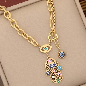 Vintage gold layered necklace with Hamsa hand and colorful evil eye charms for women
