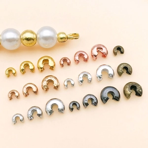 Assorted copper crescent bead covers in multiple sizes and metallic colors for DIY jewelry