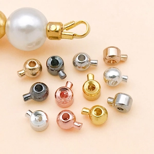 Macro shot of assorted multi-color metal jewelry end caps with pearl connector detail