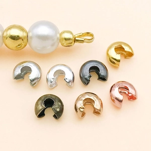 Macro shot of multi-color C-shape crimp beads for jewelry making and knot covering
