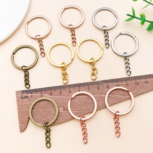 Macro shot of 30mm multicolored metal keyrings with chain links and measuring ruler