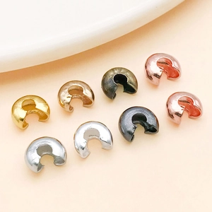 Detail of C-shaped metal bead covers in gold silver and bronze for DIY jewelry making