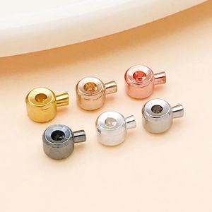 Close-up of small cylindrical DIY jewelry beads in six metallic finishes for accessories