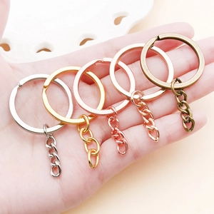 Detailed macro of 54x30mm flat key rings with 4-link chains in five metallic finishes