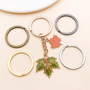Detailed macro view of five-color plating split rings and maple leaf keychain charms