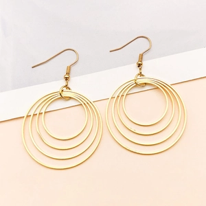 Detail view of multi-layered gold geometric concentric hoop earrings with hooks