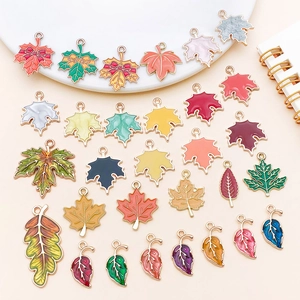 Macro detail of colorful enamel maple leaf charms with gold plating for jewelry DIY