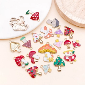 Detailed view of colorful enamel mushroom charms with gold-plated alloy rings