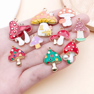Detailed close-up of colorful enamel mushroom charms with glossy finish for DIY jewelry