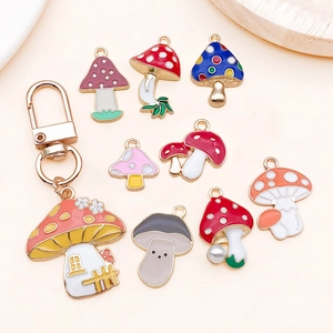 Detailed flat lay of colorful enamel mushroom charms and a mushroom house keychain