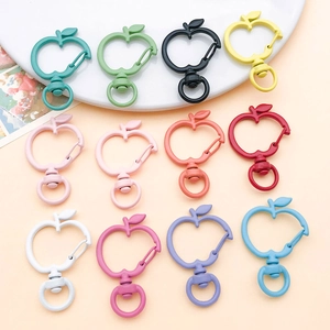Detailed flat lay of apple-shaped colorful alloy lobster clasps with matte finish
