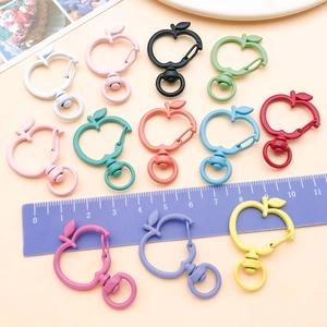 Colorful apple-shaped lobster clasps in matte finish displayed with a scale ruler