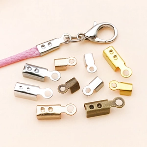 Detail of iron cord end caps in various metallic finishes used on a pink braided rope cord